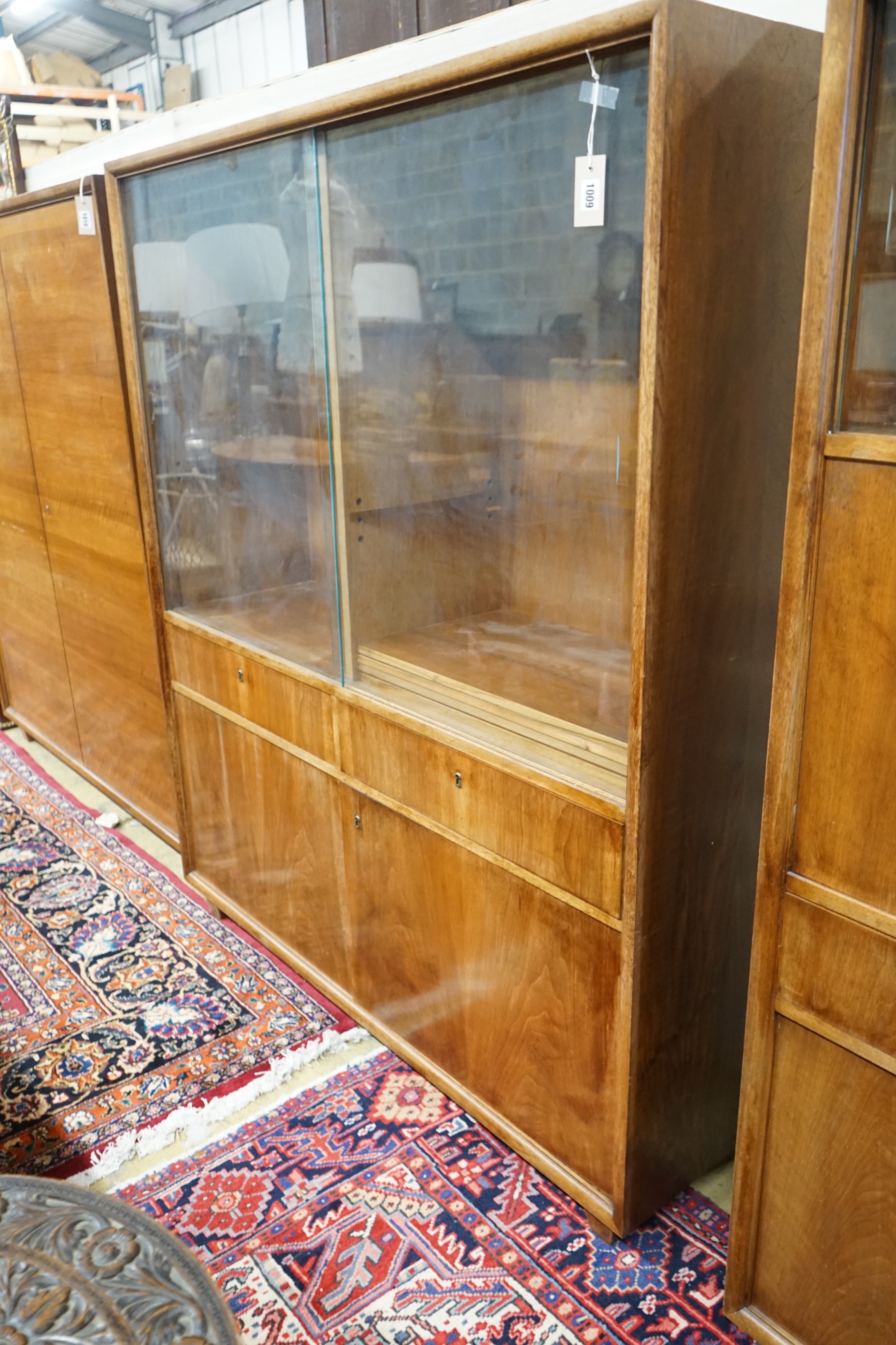 A mid century walnut bookcase by Georg Schoettle, Stuttgart, width 135cm, depth 40cm, height 160cm